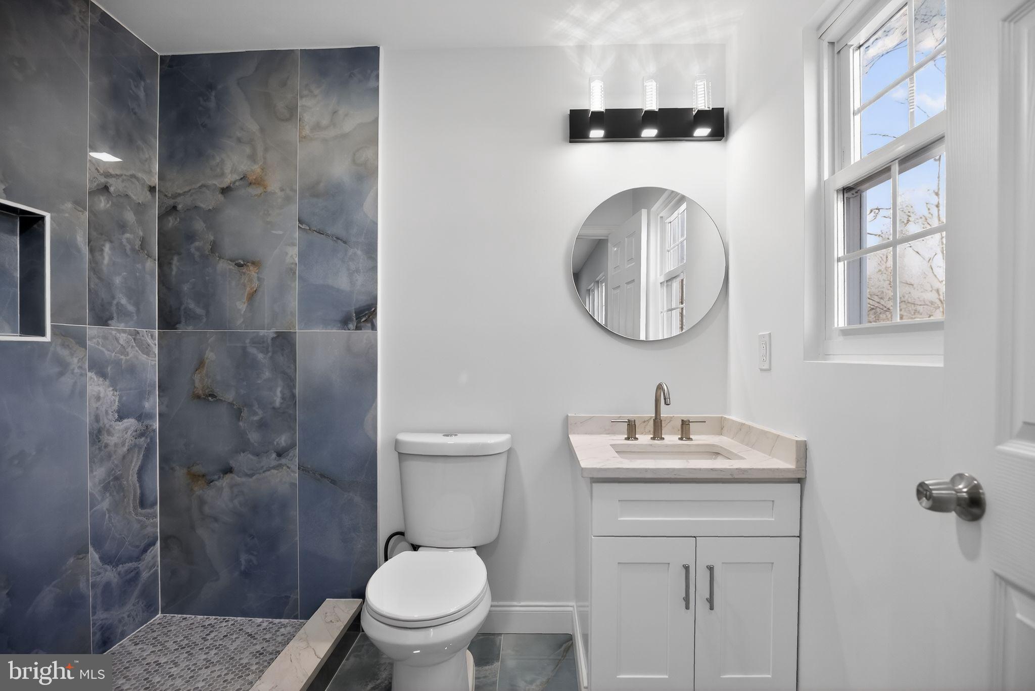 931 Woodlane Road Westampton, NJ 08060 - Photo 25 of 33 a bathroom with a toilet sink vanity granite and a shower