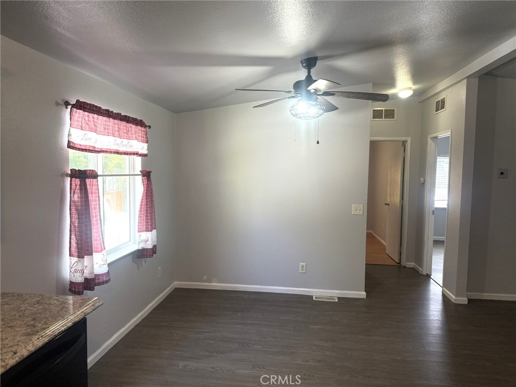6845 Floyd Way Nice, CA 95464 - Photo 14 of 59 a view of an empty room with wooden floor and a window