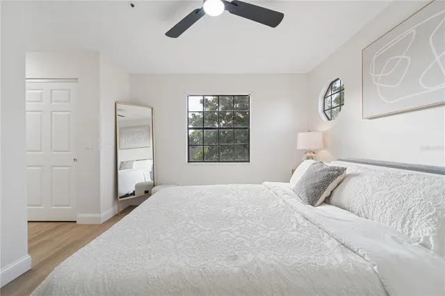 a bedroom with a large bed and a window