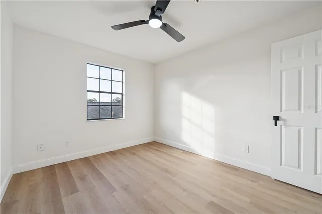wooden floor in an empty room with a window