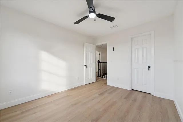 a view of an empty room with a ceiling fan