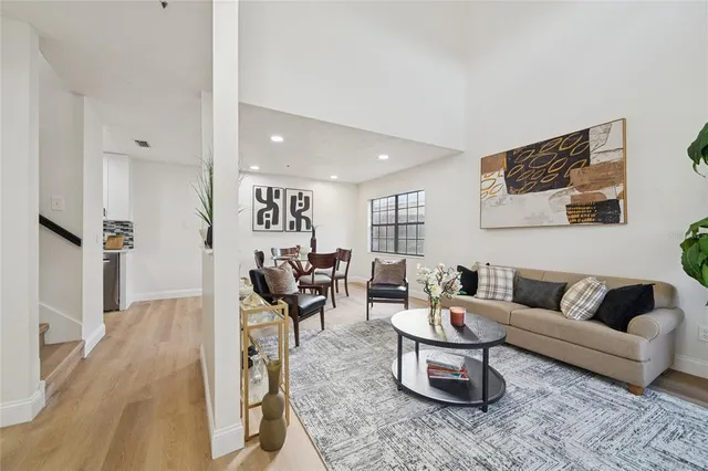 a living room with furniture wooden floor and a rug