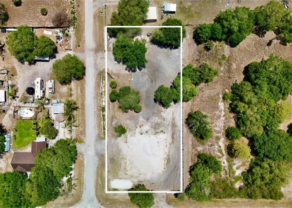 an aerial view of a house with a yard and garden
