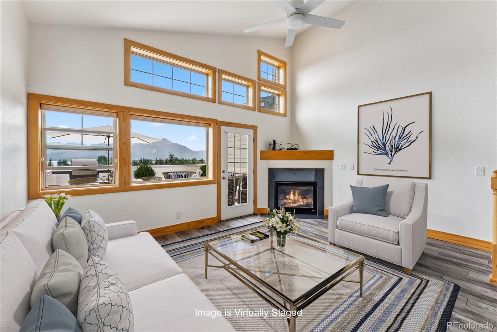 135 Main Street, Unit 214 Dillon, CO 80435 - Photo 1 of 42 a living room with furniture a fireplace and a large window