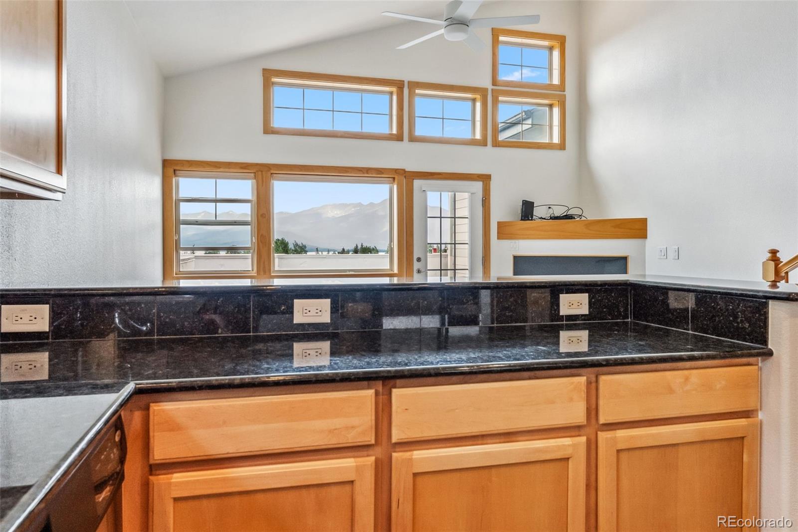 135 Main Street, Unit 214 Dillon, CO 80435 - Photo 12 of 42 a kitchen with granite countertop white cabinets and a window