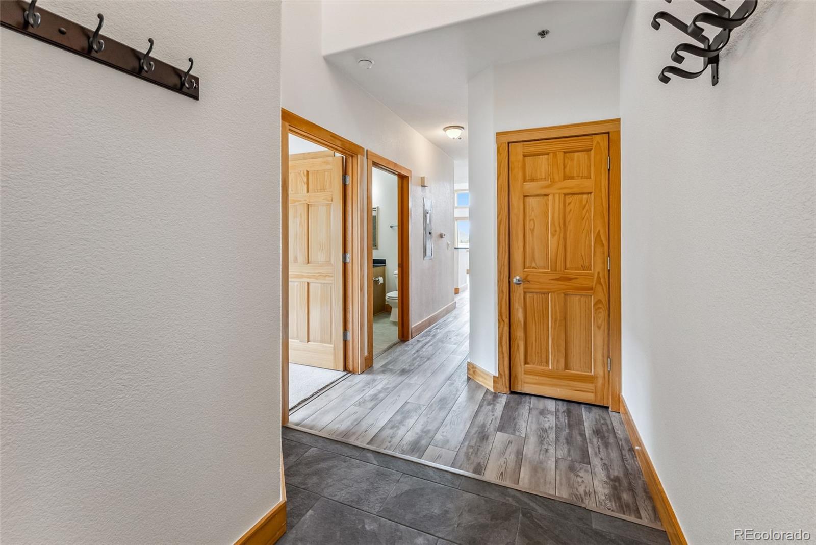 135 Main Street, Unit 214 Dillon, CO 80435 - Photo 13 of 42 a view of a hallway with wooden floor and cabinet
