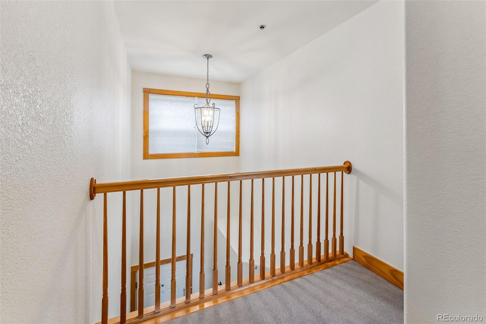 135 Main Street, Unit 214 Dillon, CO 80435 - Photo 20 of 42 a view of a hallway with wooden floor and a window