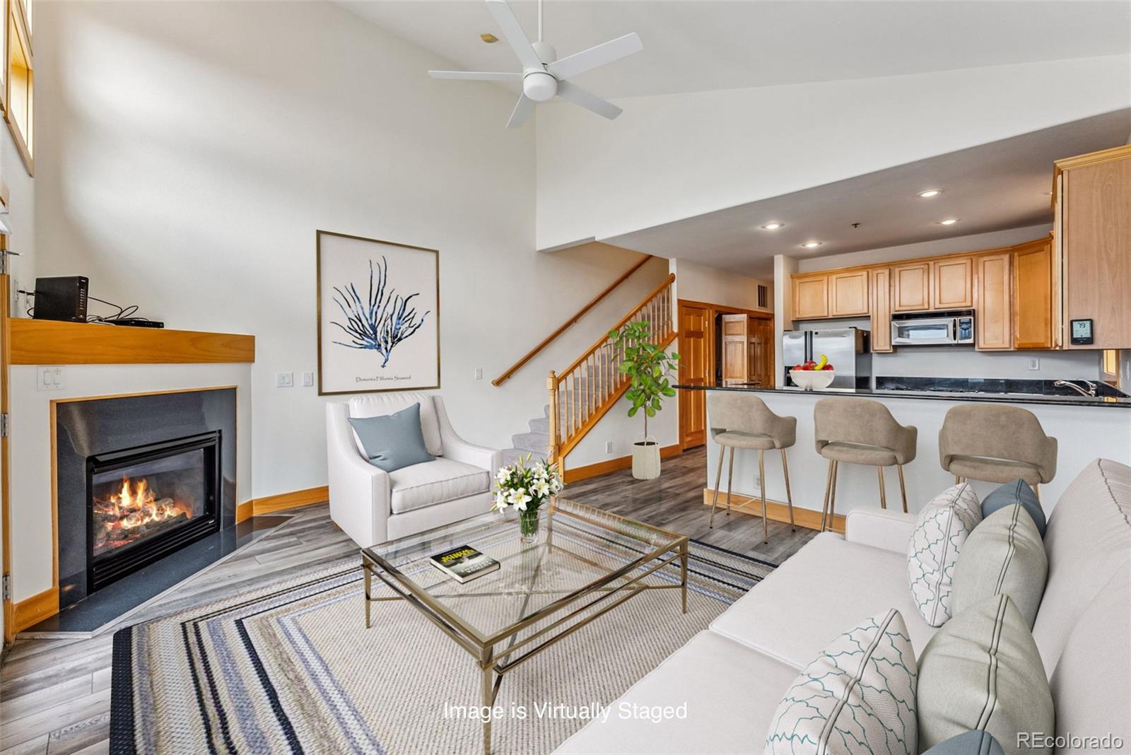 135 Main Street, Unit 214 Dillon, CO 80435 - Photo 2 of 42 a living room with furniture and a fireplace