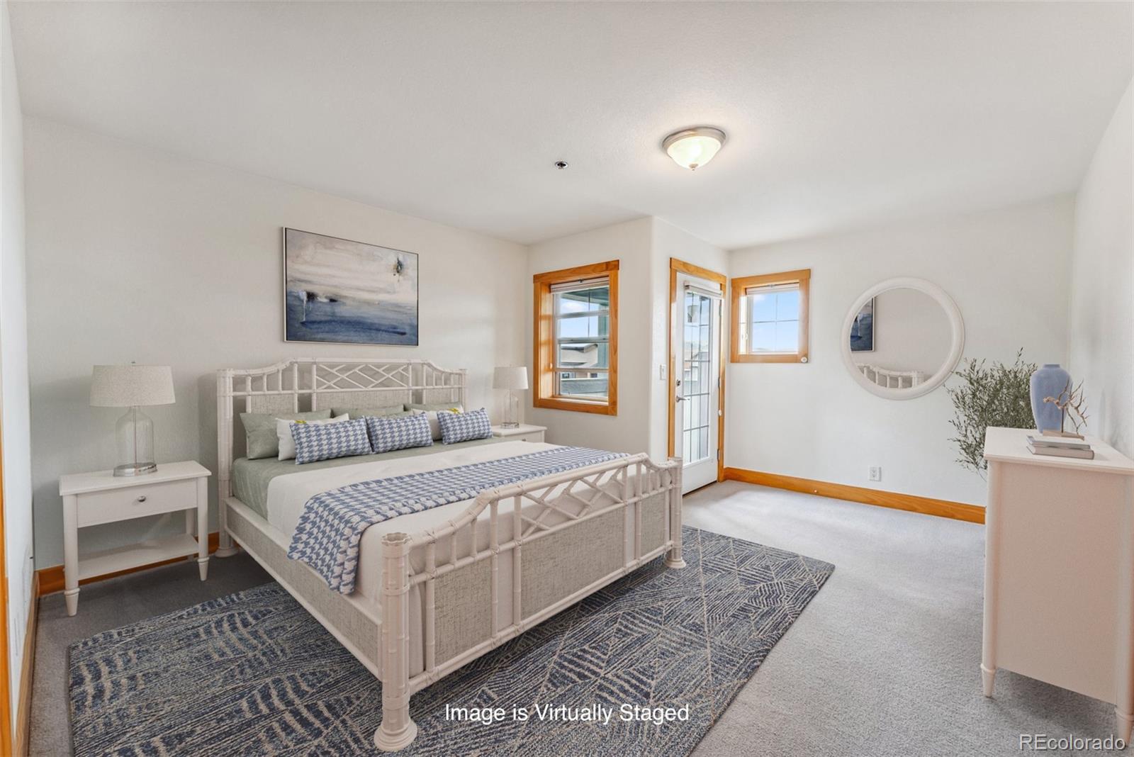 135 Main Street, Unit 214 Dillon, CO 80435 - Photo 3 of 42 a bedroom with a large bed and a chandelier