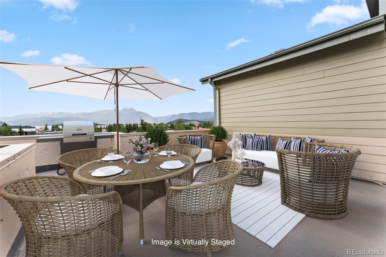 135 Main Street, Unit 214 Dillon, CO 80435 - Photo 4 of 42 a outdoor dining space with furniture and umbrella