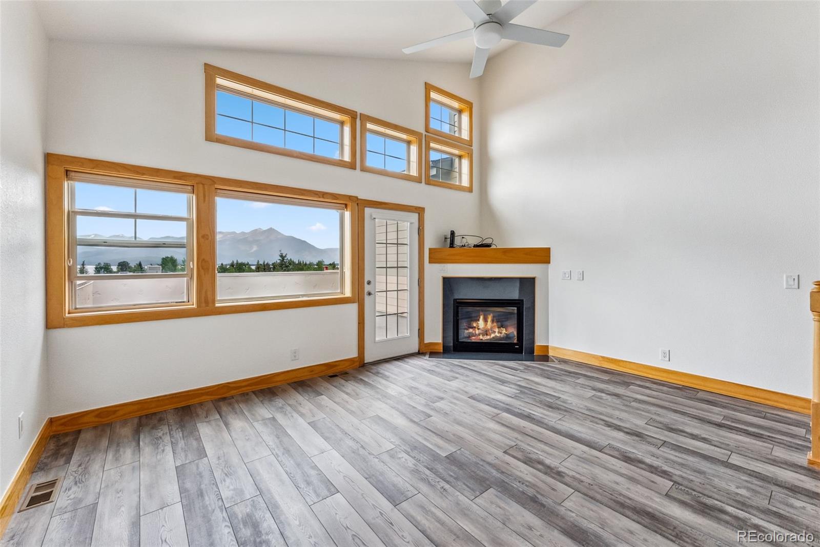 135 Main Street, Unit 214 Dillon, CO 80435 - Photo 6 of 42 a view of an empty room with wooden floor fireplace and a window