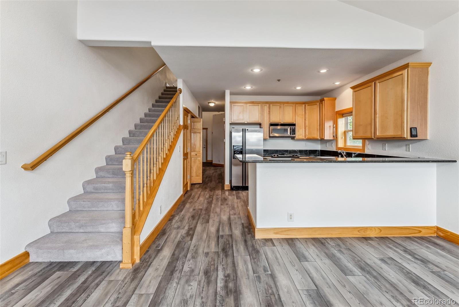 135 Main Street, Unit 214 Dillon, CO 80435 - Photo 7 of 42 a view of kitchen with wooden floor and electronic appliances