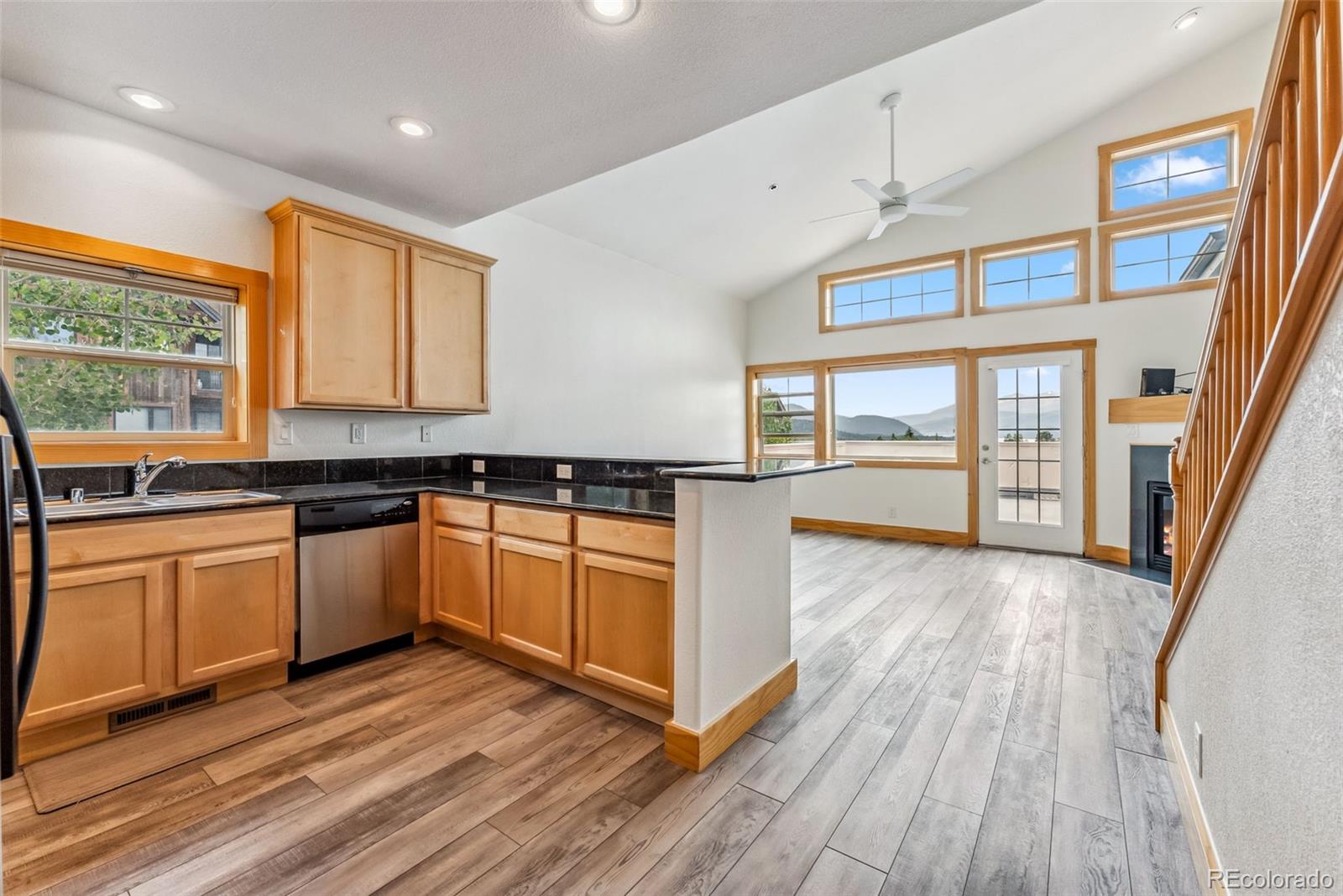 135 Main Street, Unit 214 Dillon, CO 80435 - Photo 8 of 42 a large kitchen with stainless steel appliances granite countertop a stove and a wooden floors