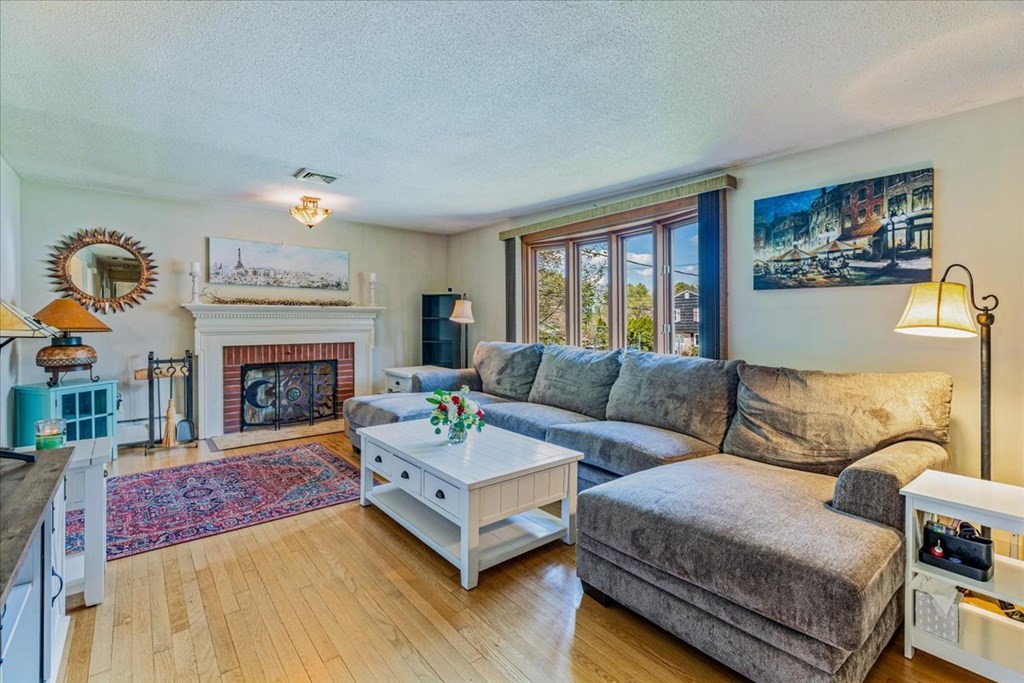 8 Stonewood Drive Canton, MA 02021 - Photo 2 of 29 a living room with furniture and a fireplace