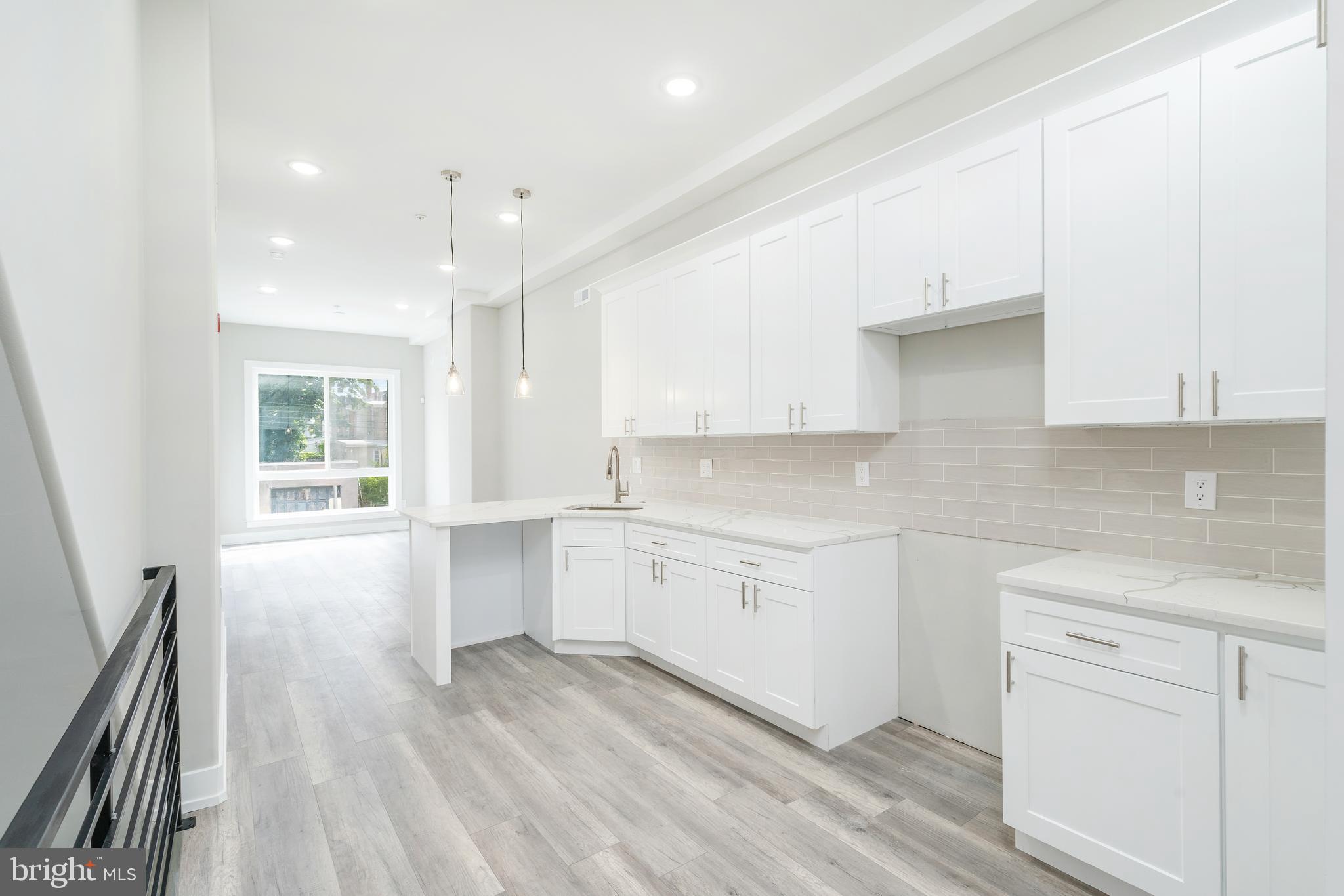 103 East Duval Street, Unit 1 Philadelphia, PA 19144 - Photo 2 of 32 a kitchen with granite countertop white cabinets and white appliances