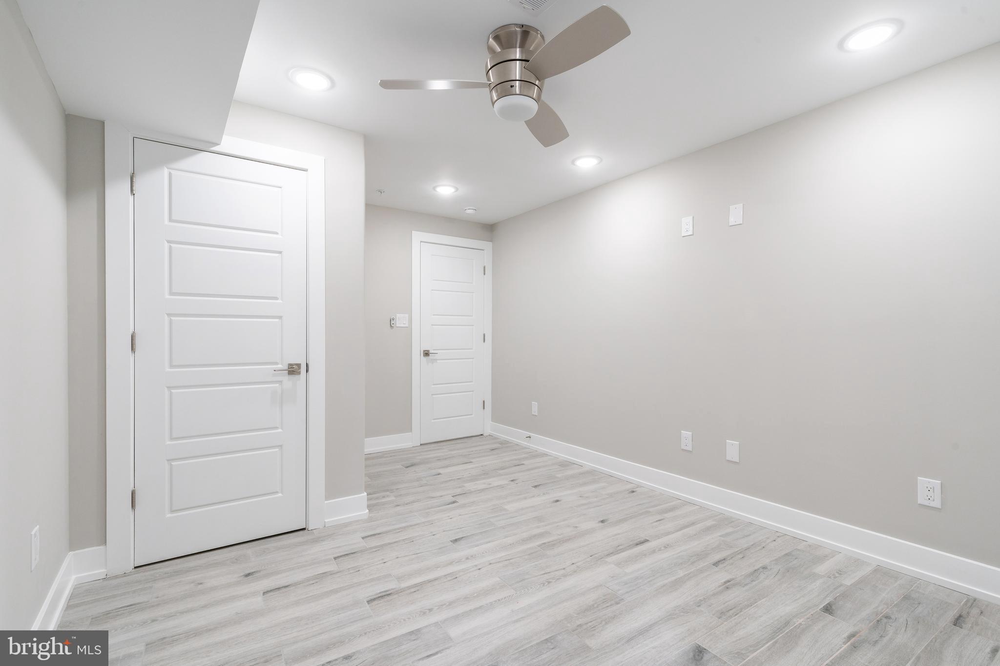 103 East Duval Street, Unit 1 Philadelphia, PA 19144 - Photo 22 of 32 an empty room with wooden floor ceiling fan and windows