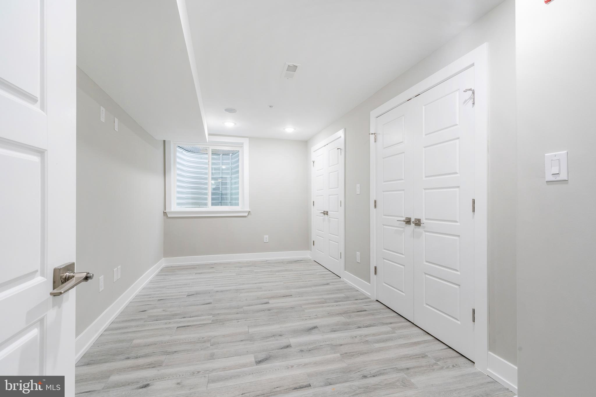103 East Duval Street, Unit 1 Philadelphia, PA 19144 - Photo 24 of 32 a view of an empty room with wooden floor and a window