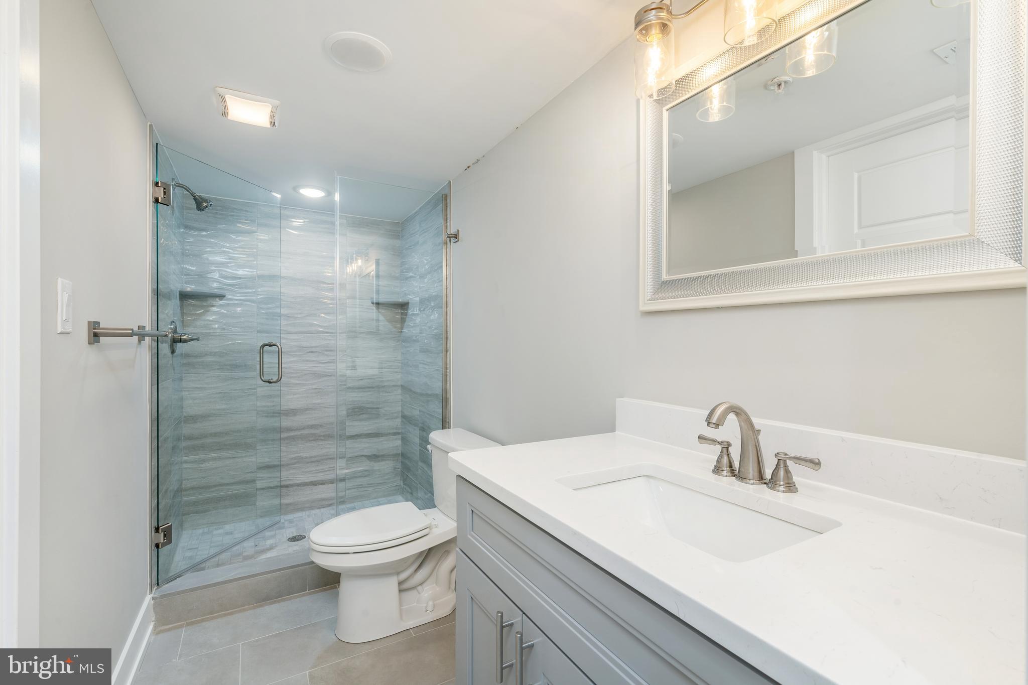 103 East Duval Street, Unit 1 Philadelphia, PA 19144 - Photo 26 of 32 a bathroom with a sink a toilet and shower