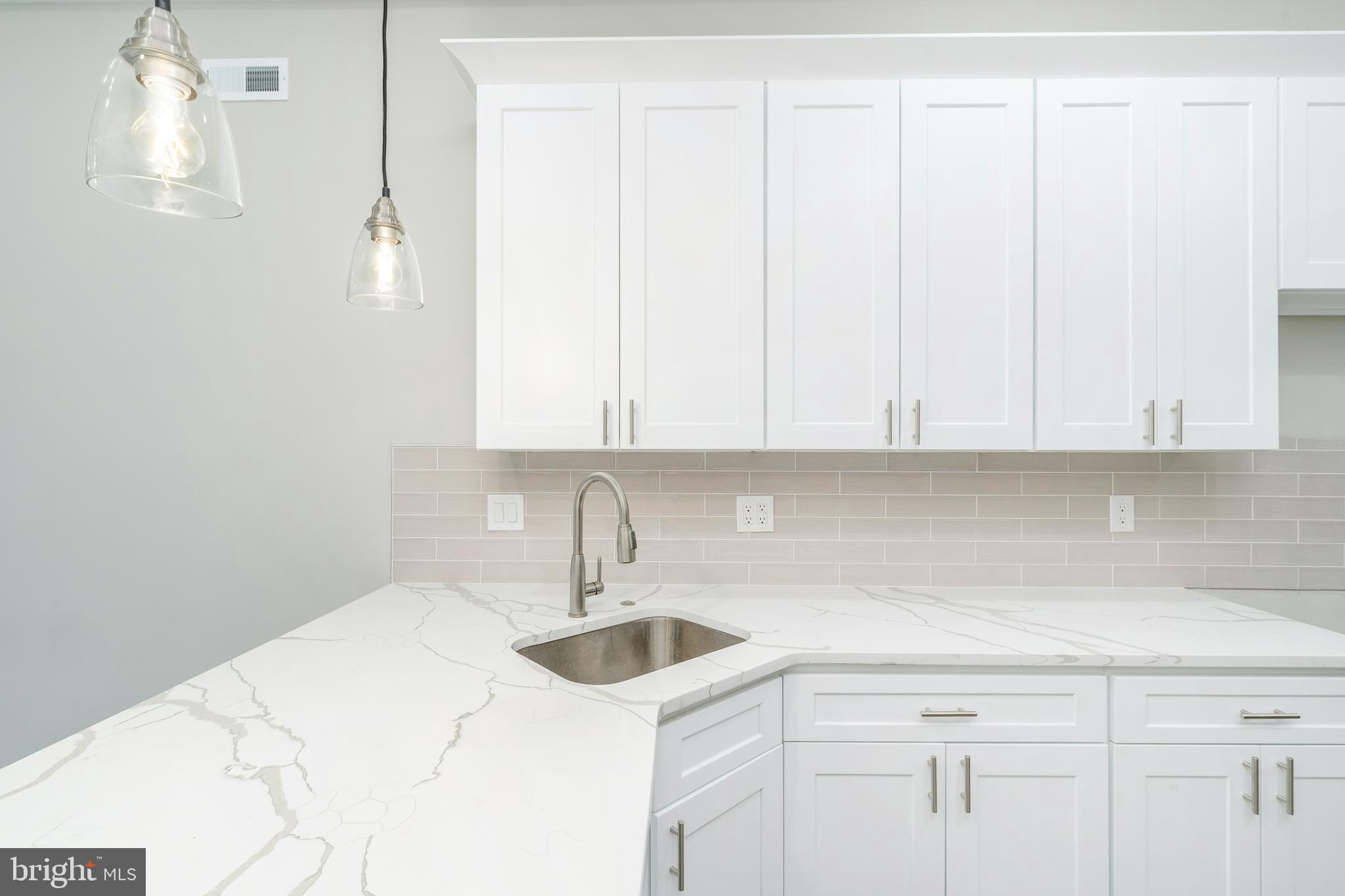 103 East Duval Street, Unit 1 Philadelphia, PA 19144 - Photo 9 of 32 a kitchen with a sink and cabinets