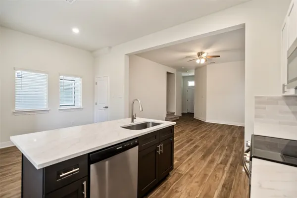 a kitchen with a sink dishwasher and a stove