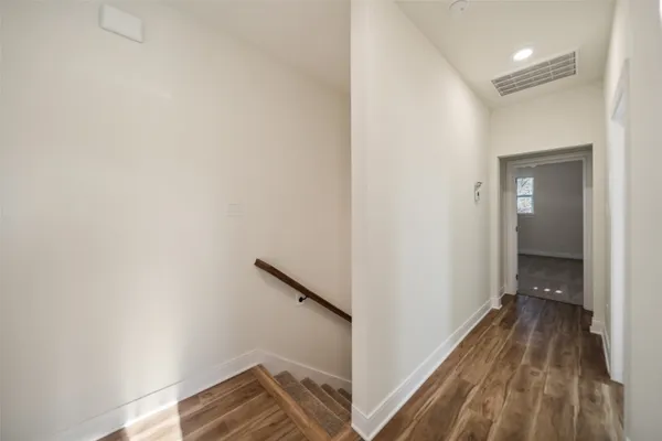 a view of a room with wooden floor and staircase