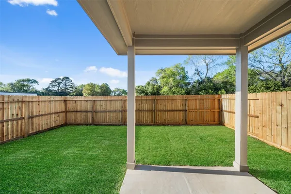 a view of a house with a yard and deck