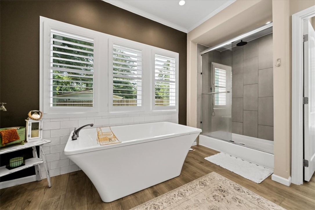 116 Parkview Road Iva, SC 29655 - Photo 24 of 44 Indulge in this serene primary bath, featuring a generous soaking tub positioned beneath multiple sun-filled windows.
