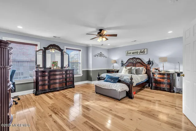 a bedroom with a large bed and a chandelier