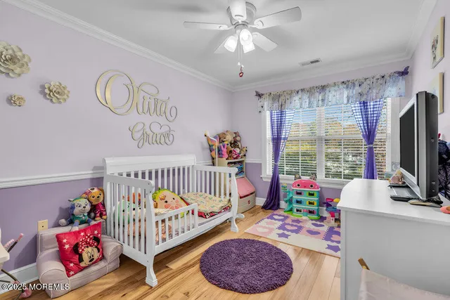 a bedroom with furniture a baby crib and a window