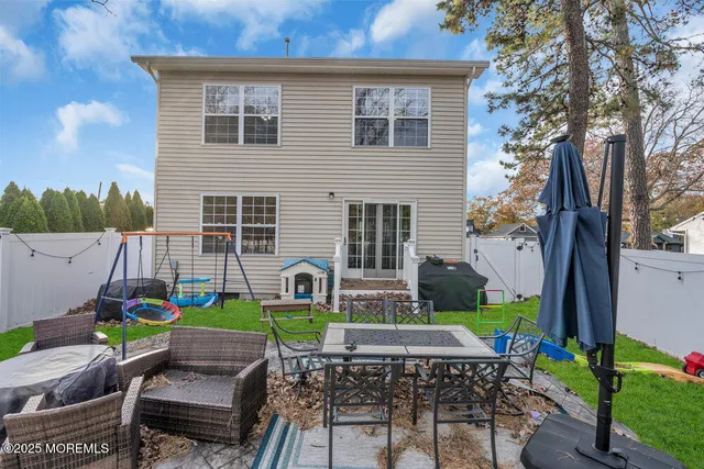 a view of backyard of house with seating space