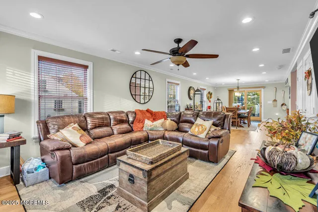 a living room with furniture kitchen area and a window