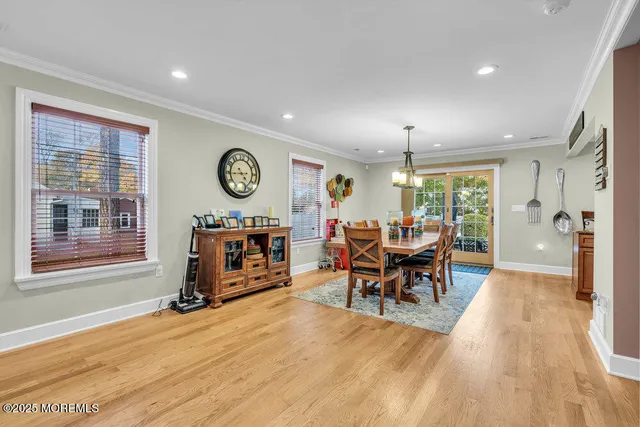 a view of a a dining room with furniture window and wooden floor