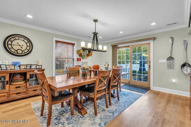 a dining room with furniture a chandelier and a rug