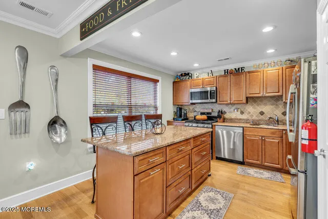 a kitchen with stainless steel appliances granite countertop a sink stove and cabinets
