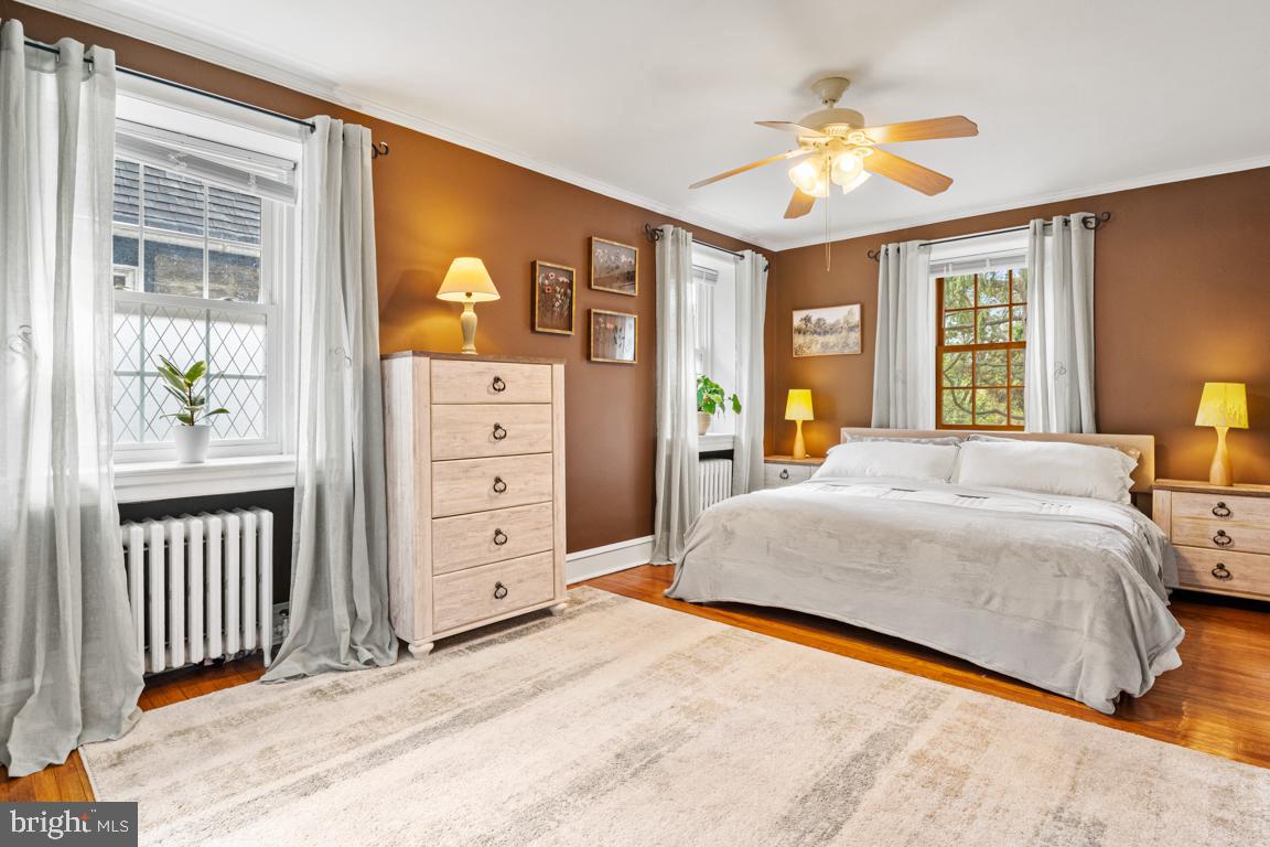 8023 Seminole Street Philadelphia, PA 19118 - Photo 20 of 42 a bedroom with a bed and a chandelier