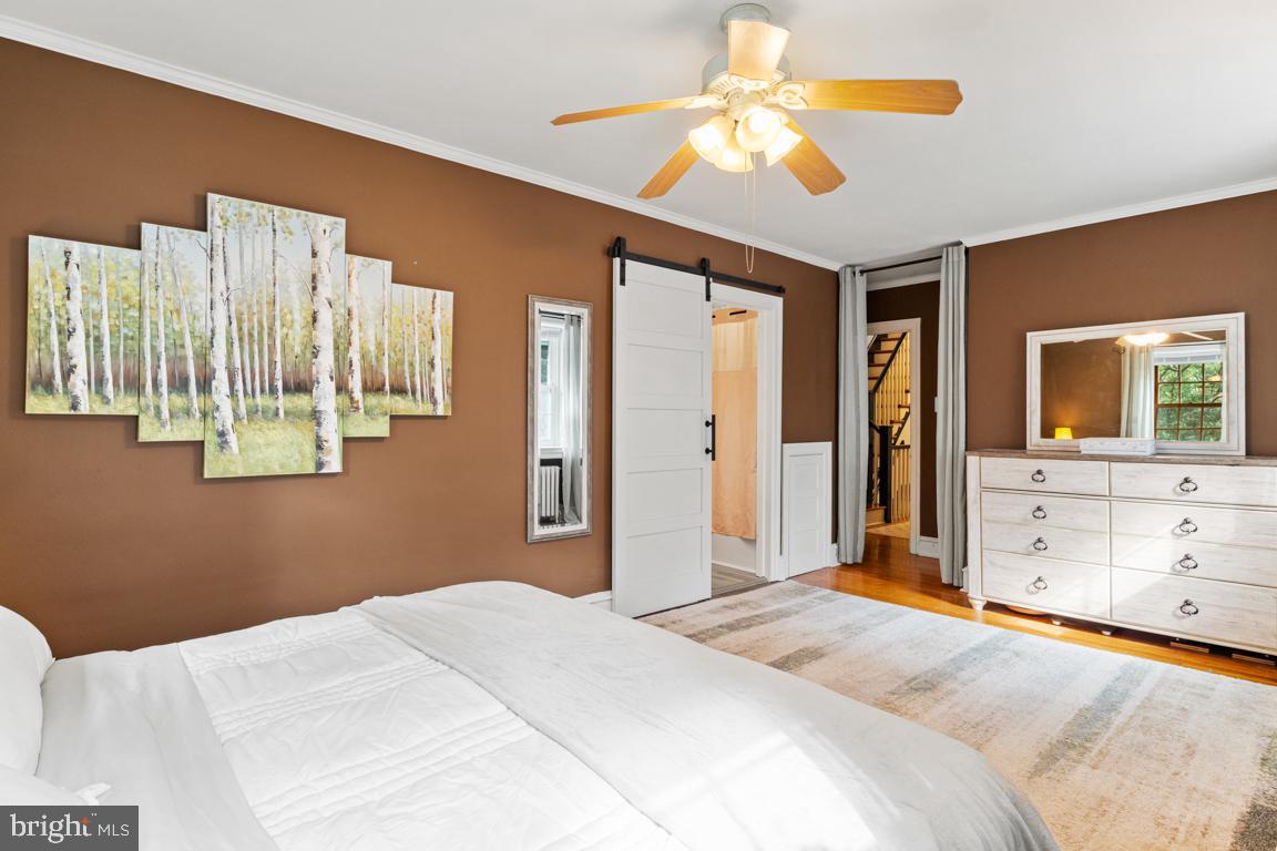 8023 Seminole Street Philadelphia, PA 19118 - Photo 21 of 42 a bedroom with a bed and a chandelier