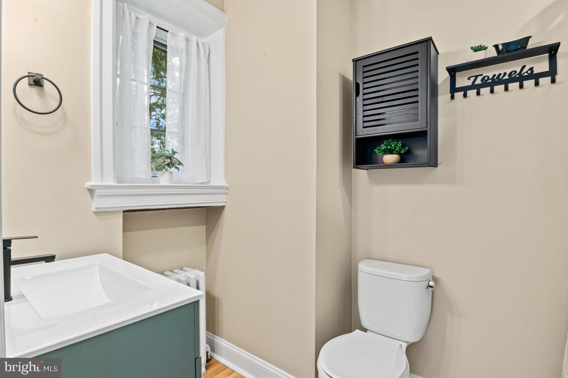 8023 Seminole Street Philadelphia, PA 19118 - Photo 23 of 42 a bathroom with a toilet sink and mirror