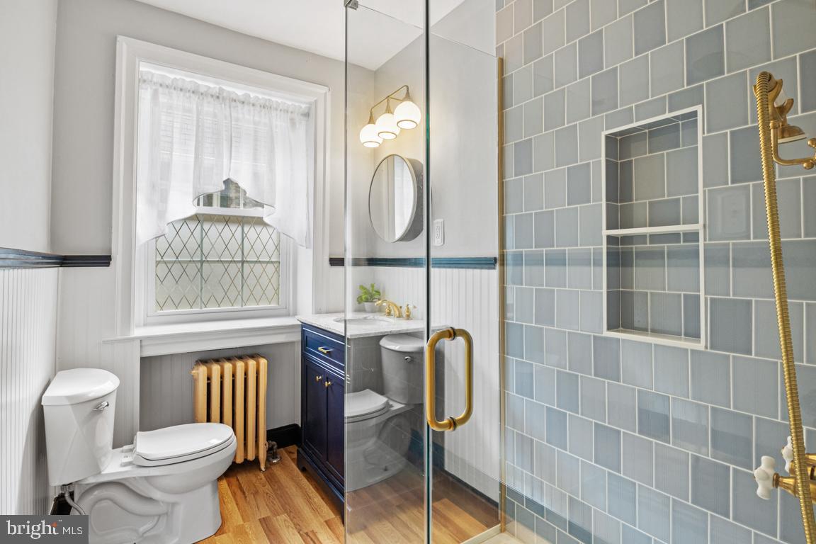8023 Seminole Street Philadelphia, PA 19118 - Photo 29 of 42 a bathroom with a toilet mirror and shower