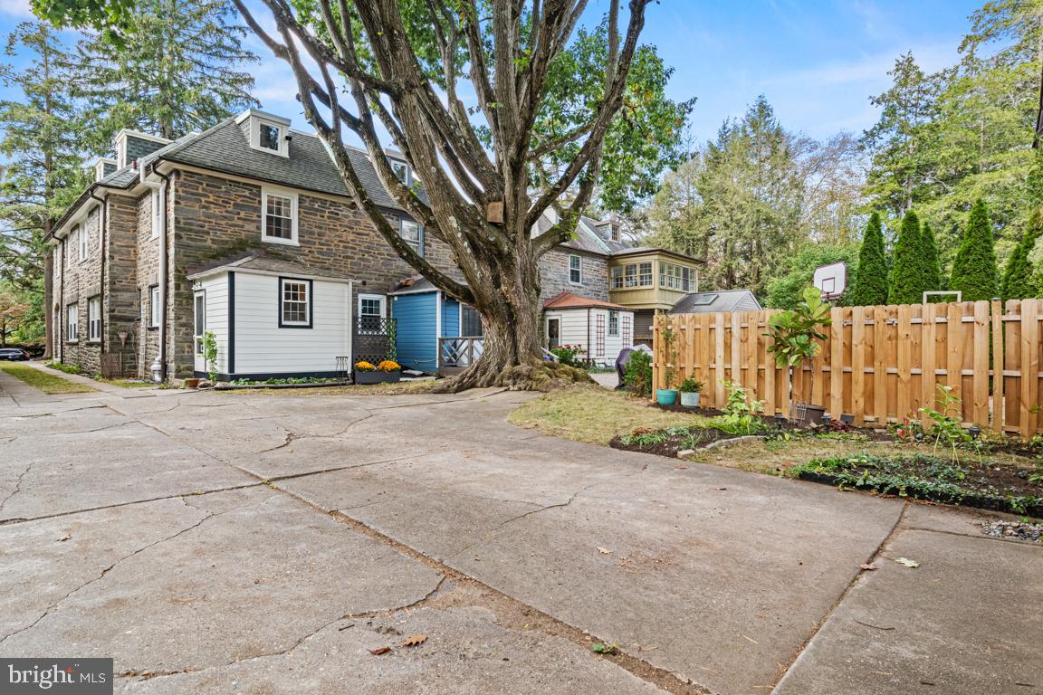 8023 Seminole Street Philadelphia, PA 19118 - Photo 38 of 42 a front view of a house with a yard and garage