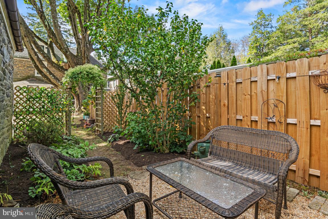 8023 Seminole Street Philadelphia, PA 19118 - Photo 40 of 42 a view of a patio with table and chairs potted plants and large tree