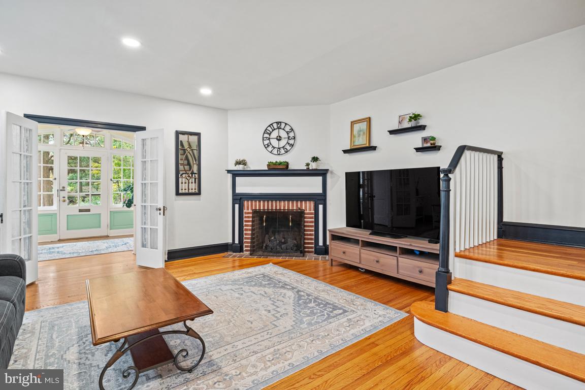 8023 Seminole Street Philadelphia, PA 19118 - Photo 8 of 42 a living room with furniture flat screen tv and a fireplace