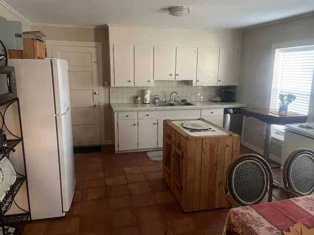 a utility room with sink dryer and washer