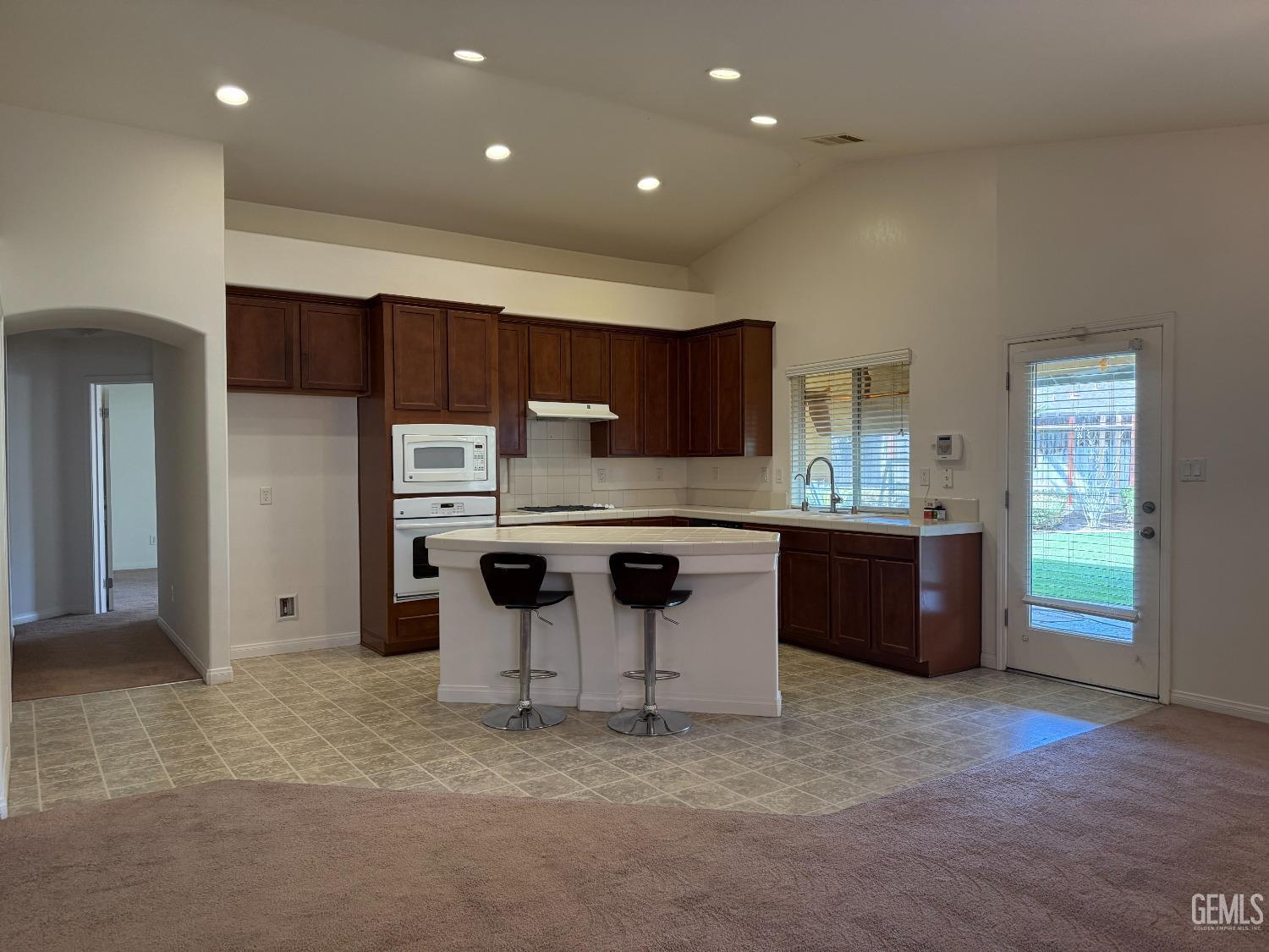 Undisclosed Address Bakersfield, CA 93311 - Photo 4 of 23 a kitchen with stainless steel appliances granite countertop a stove a sink and a refrigerator