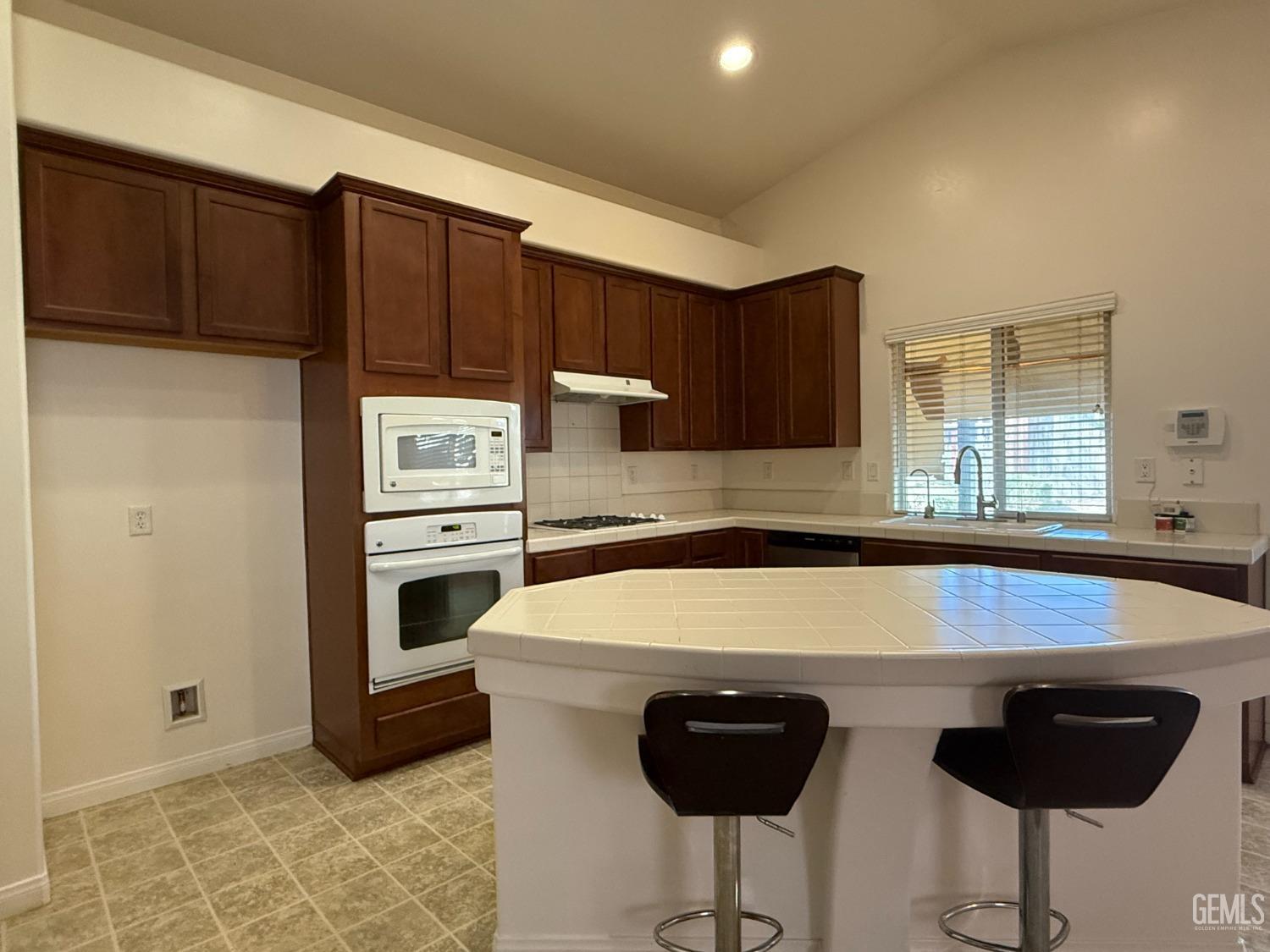 Undisclosed Address Bakersfield, CA 93311 - Photo 5 of 23 a kitchen with a sink cabinets and appliances