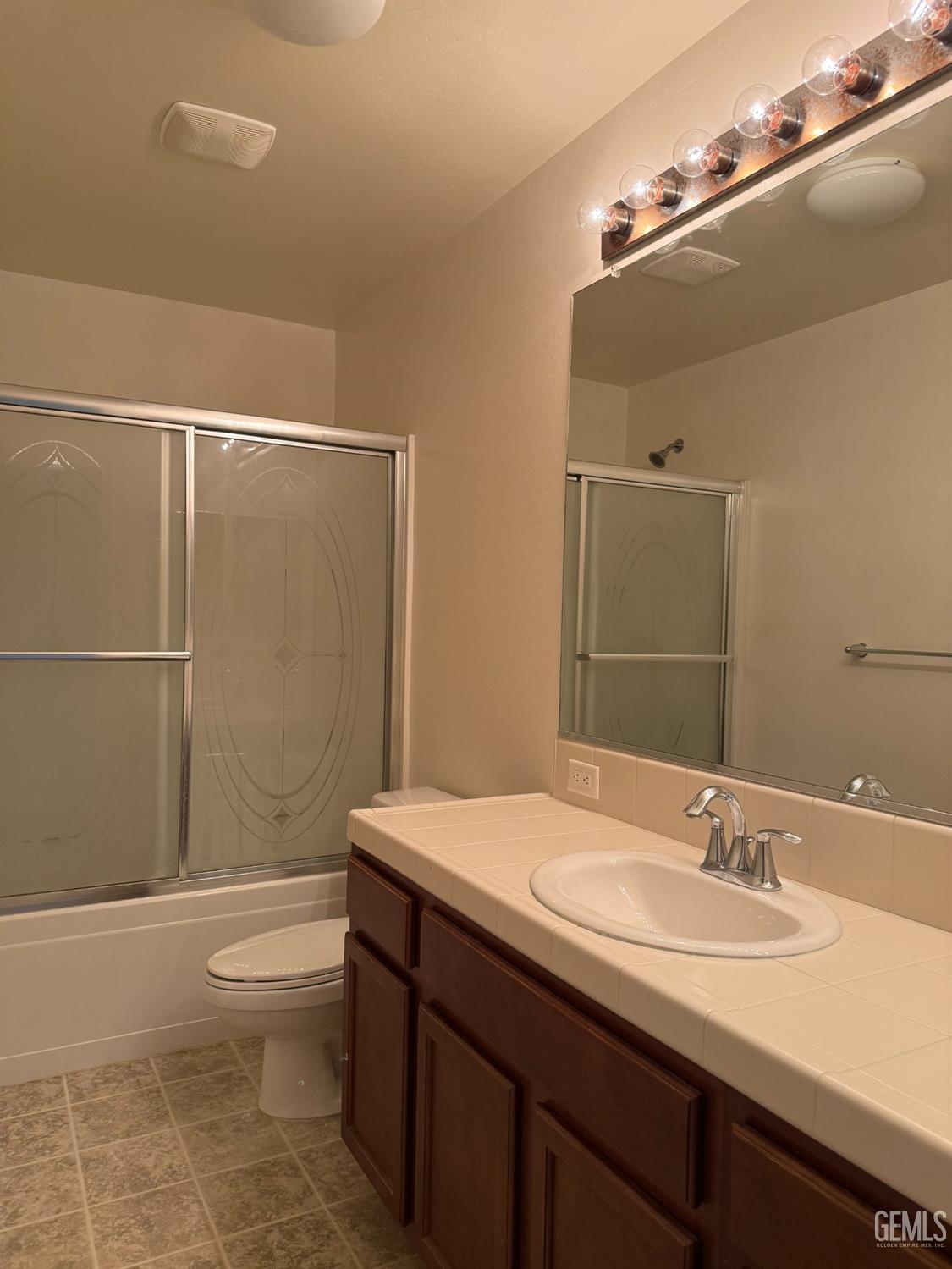 Undisclosed Address Bakersfield, CA 93311 - Photo 10 of 23 a bathroom with a granite countertop sink toilet and shower