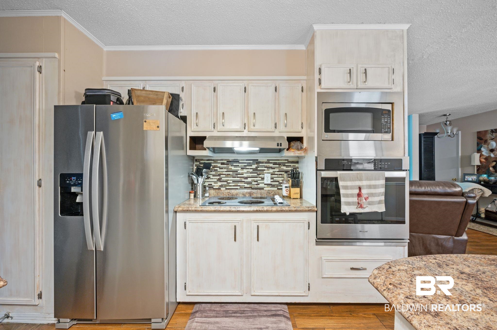 4566 McCrary Road, Unit A Semmes, AL 36575 - Photo 10 of 28 Kitchen featuring a textured ceiling, wood-type flooring, and stainless steel appliances