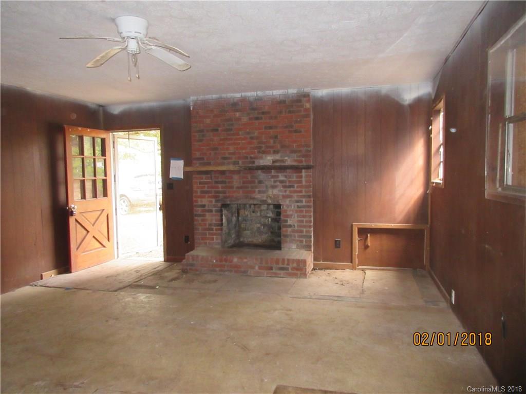 662 Mcguinn Road Mill Spring, NC 28756 - Photo 5 of 15 a view of an empty room with a fireplace and a window