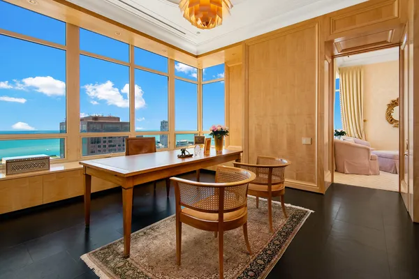 a spacious bedroom with a bed table and window