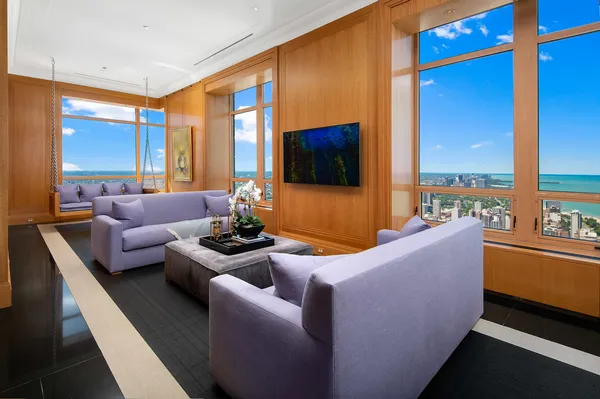 a living room with furniture and a floor to ceiling window