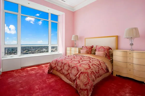 a bedroom with furniture and a flat screen tv